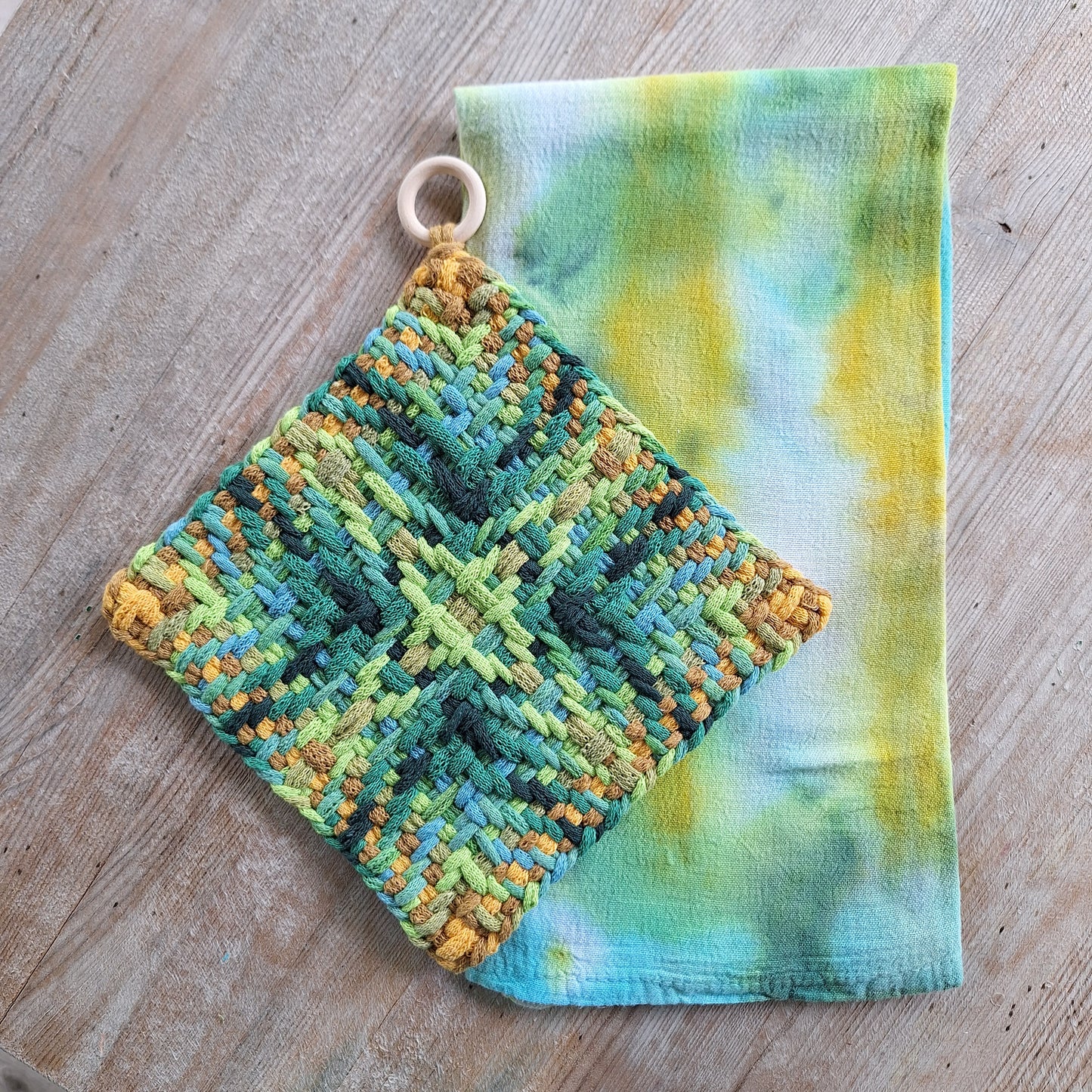 Set of a hand dyed dishtowel and handwoven potholder in shades of green and ochre