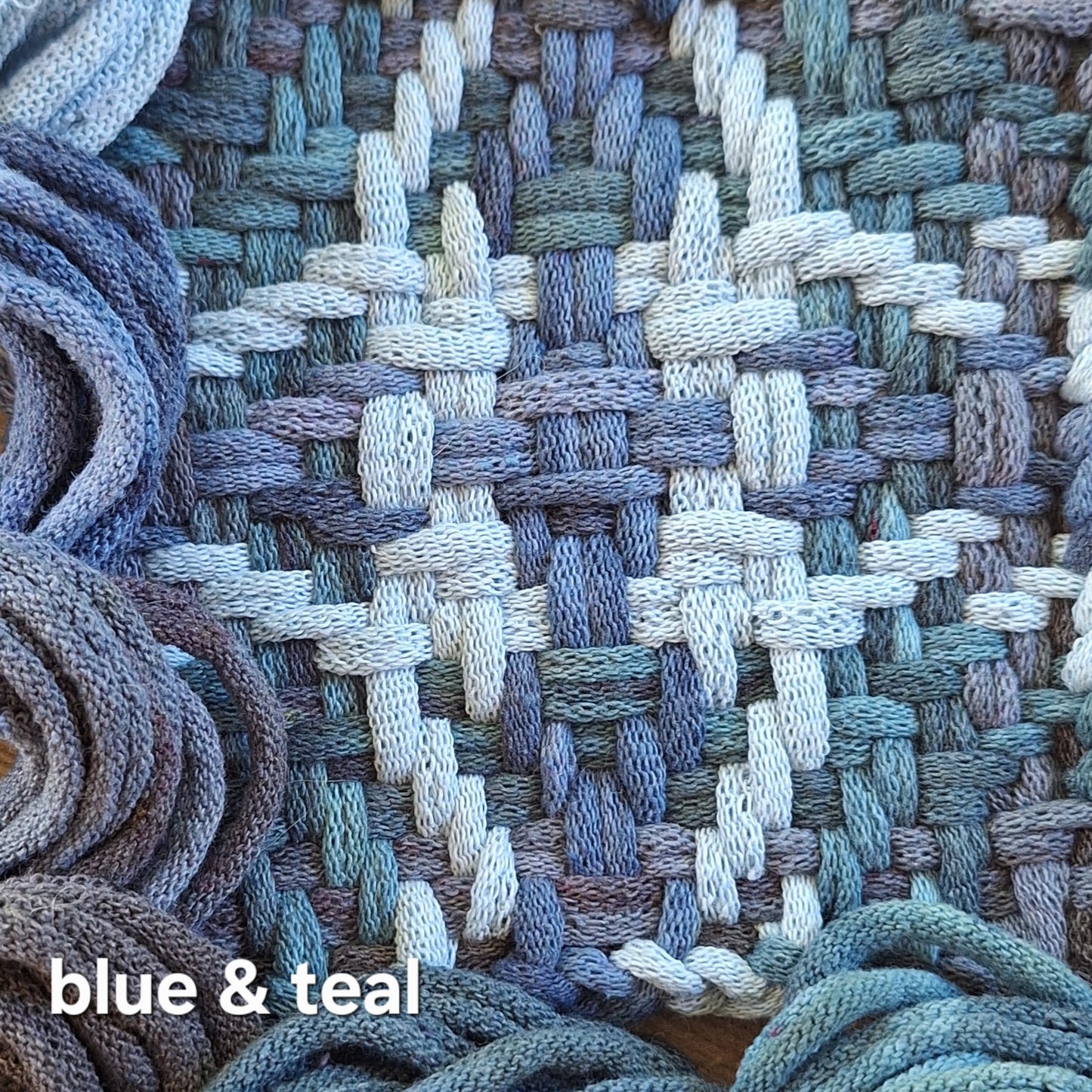 Blue and teal woven potholder in the chunky star pattern