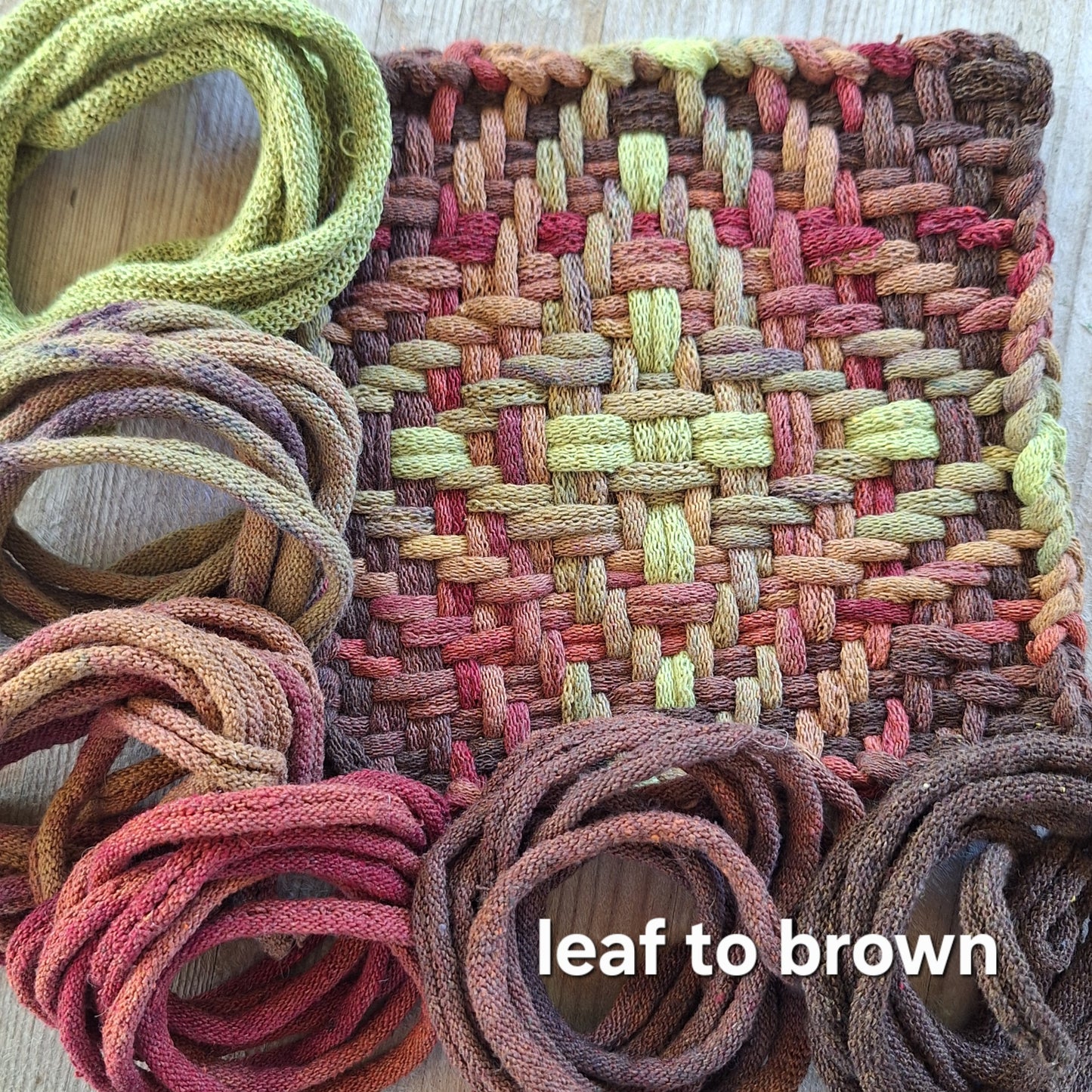 Chunky Star woven potholder with handy dyed loops showing color transition from leaf to brown on a wooden surface.