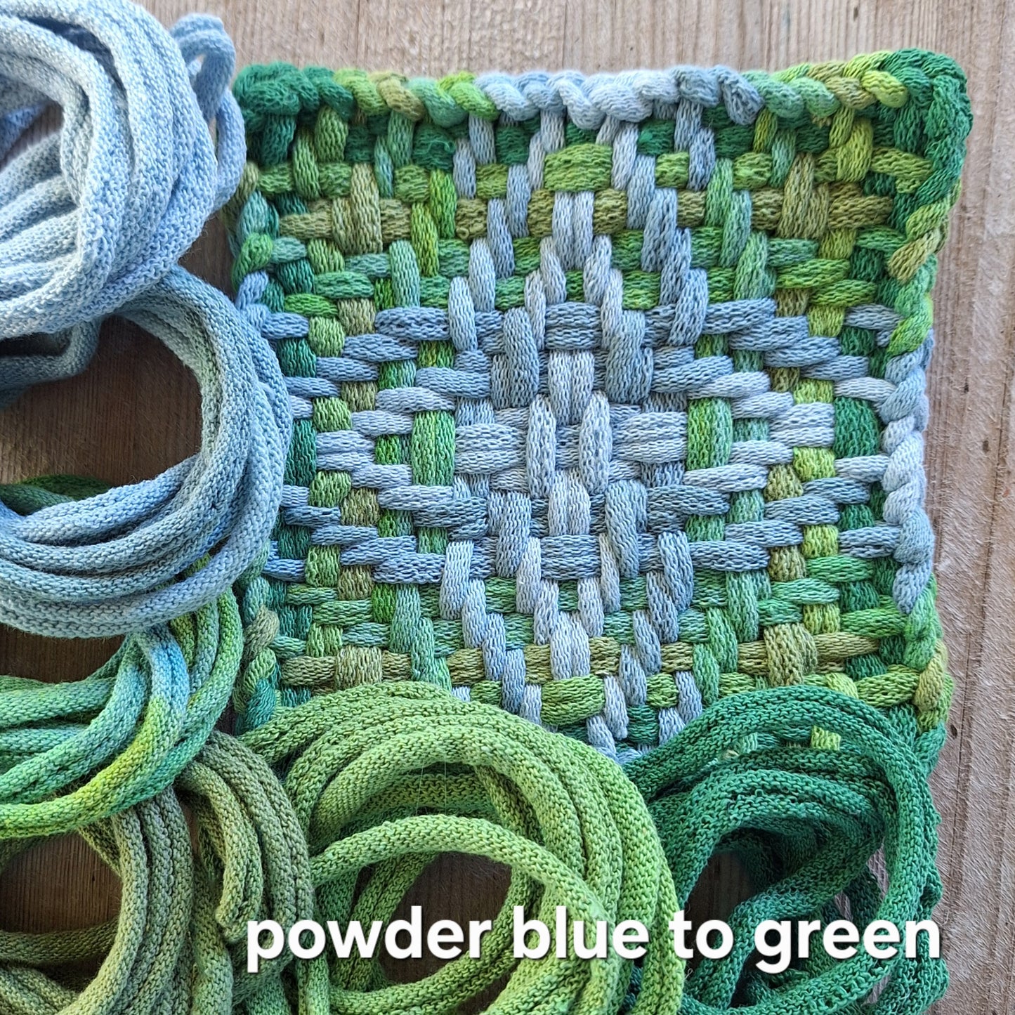 Chunky Star woven potholder with gradient from powder blue to green on a wooden surface