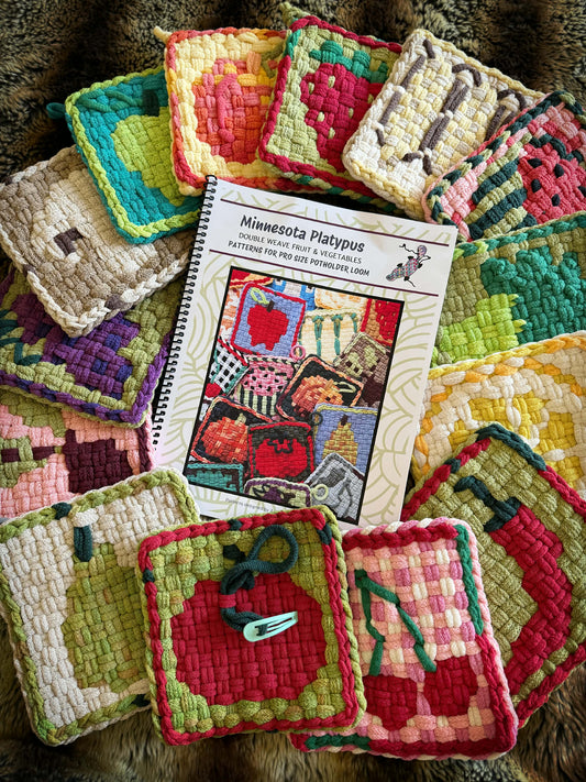 Colorful woven potholders with a pattern book on top