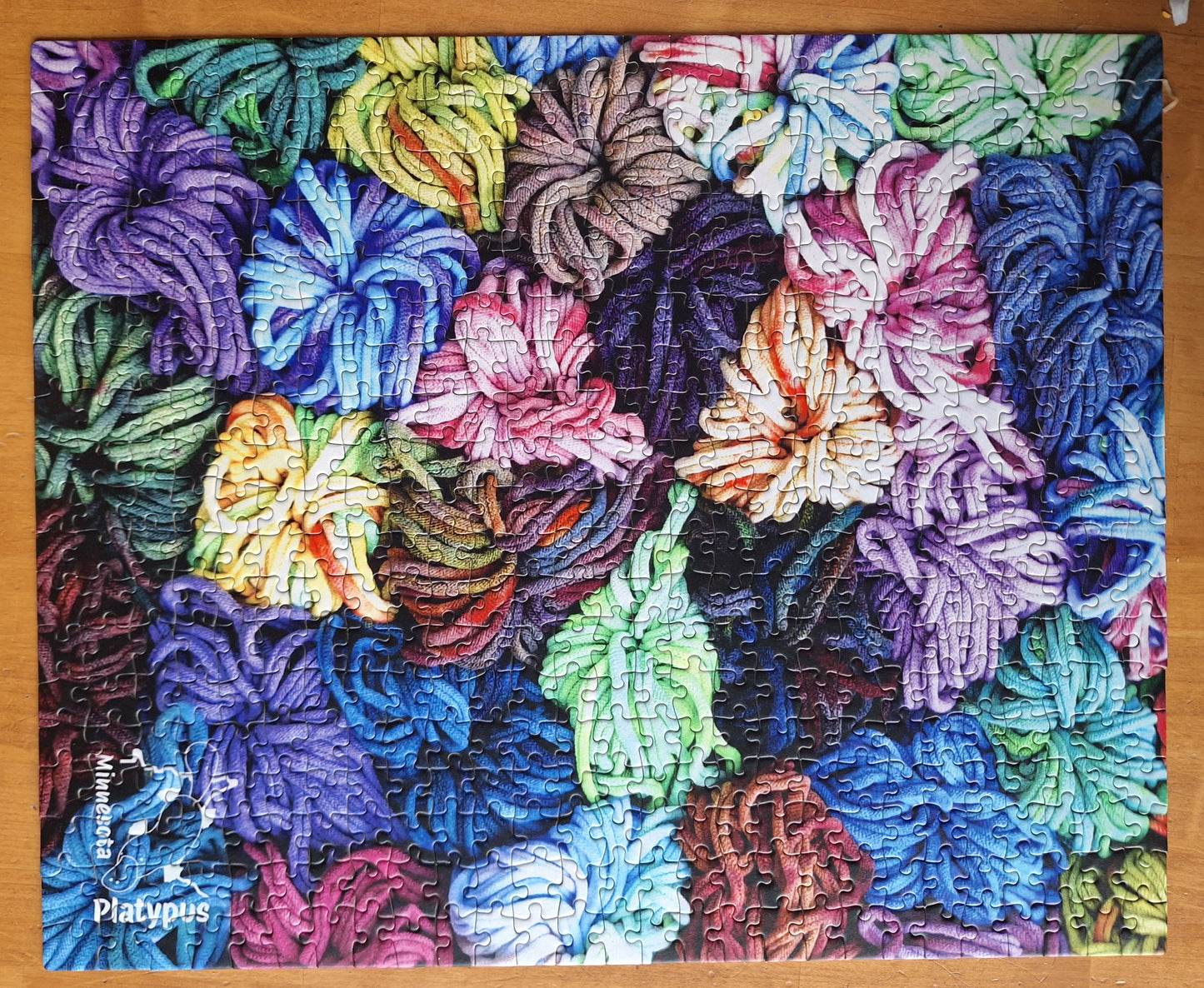 Completed colorful loops jigsaws on a wooden table
