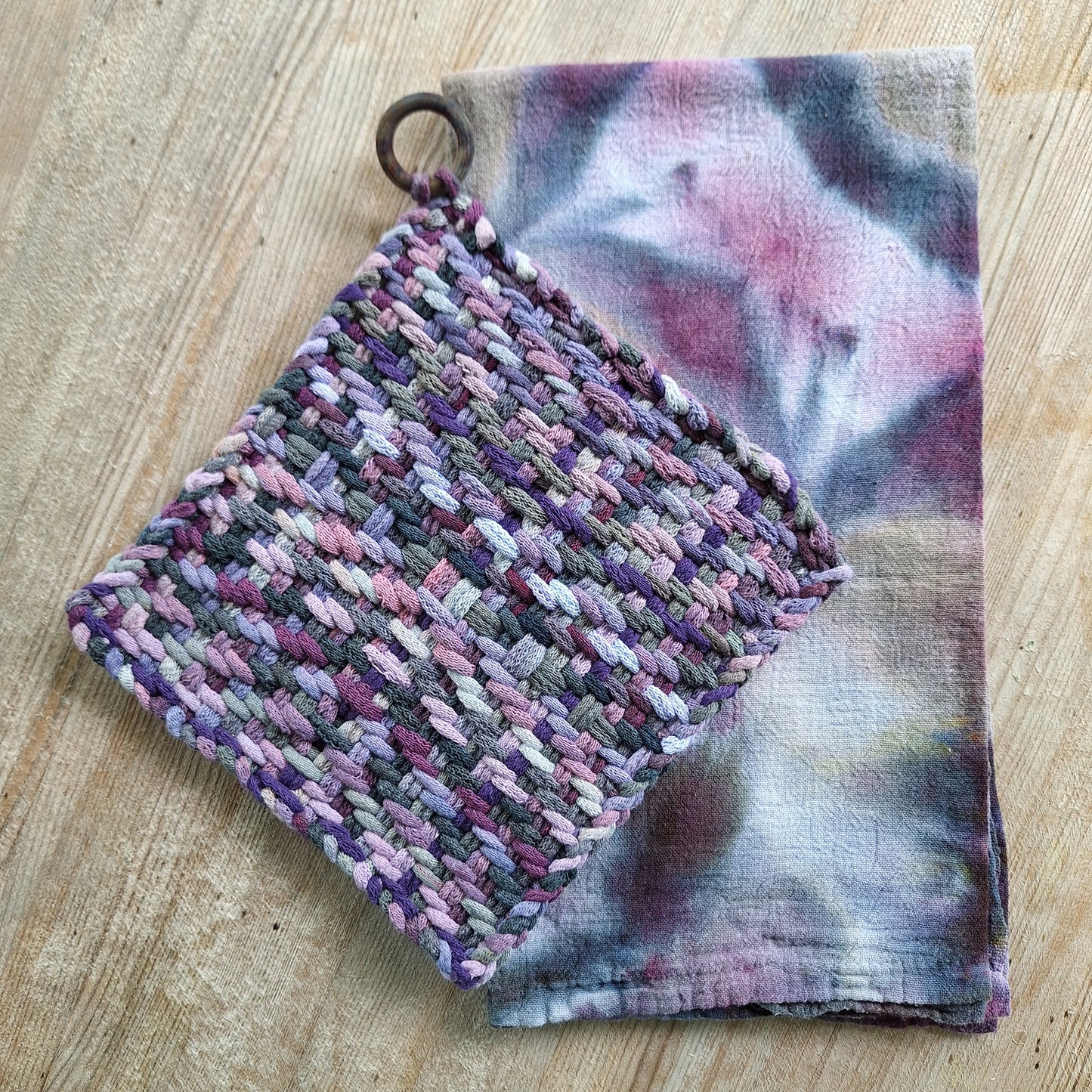 set of a hand dyed dishtowel and a handwoven potholder in shades of purple and grey