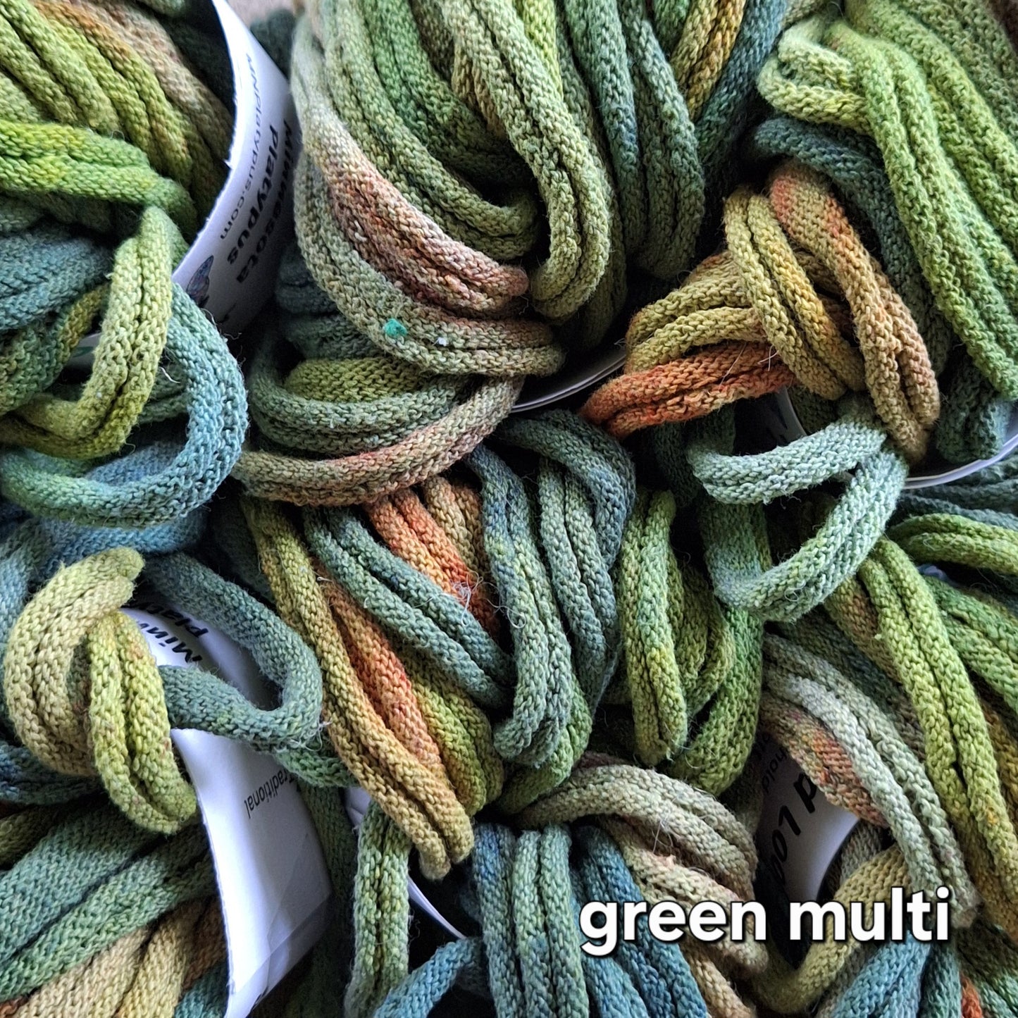 A mix of green potholder loops hand dyed by MNPlatypus