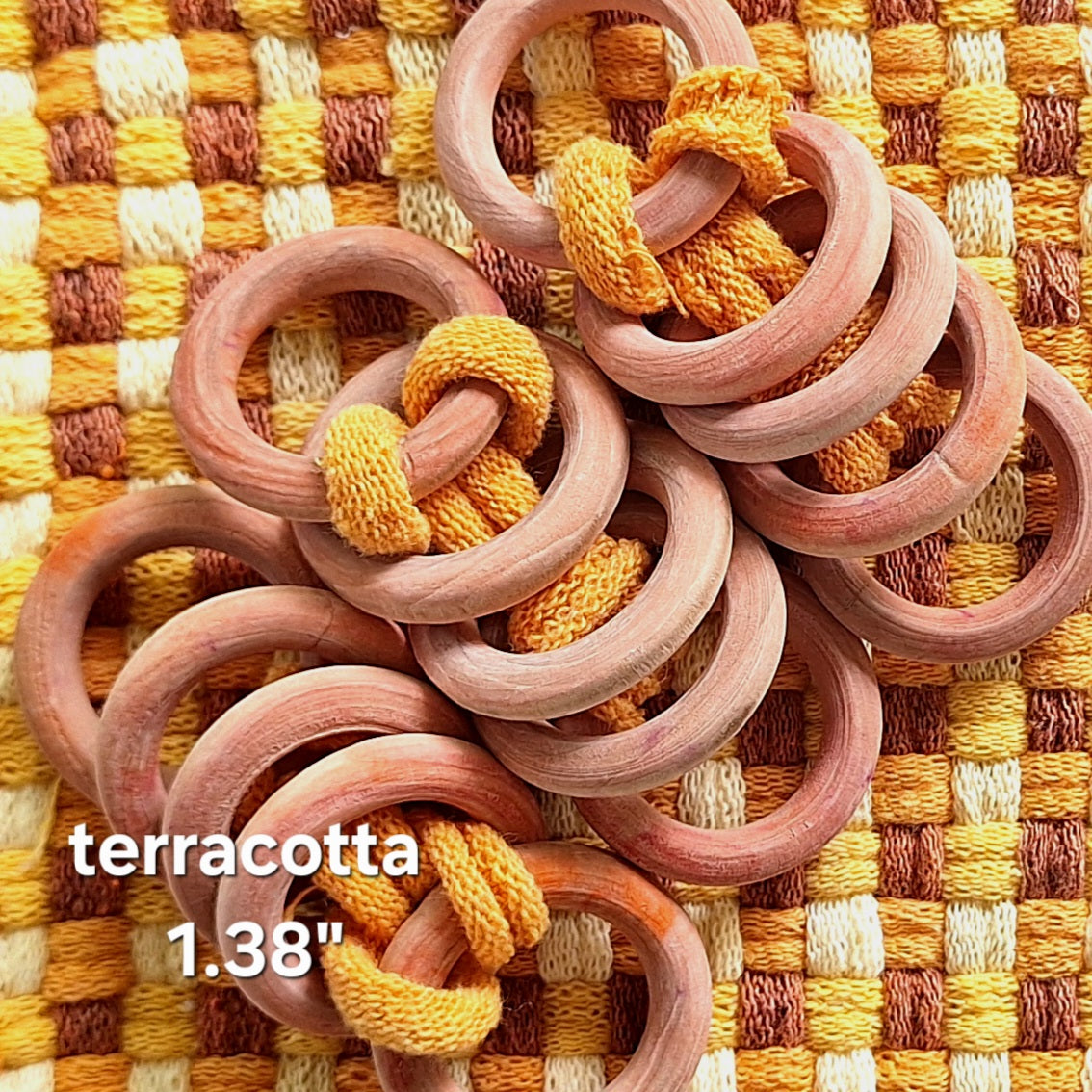 sets of orange wooden rings on a woven potholder