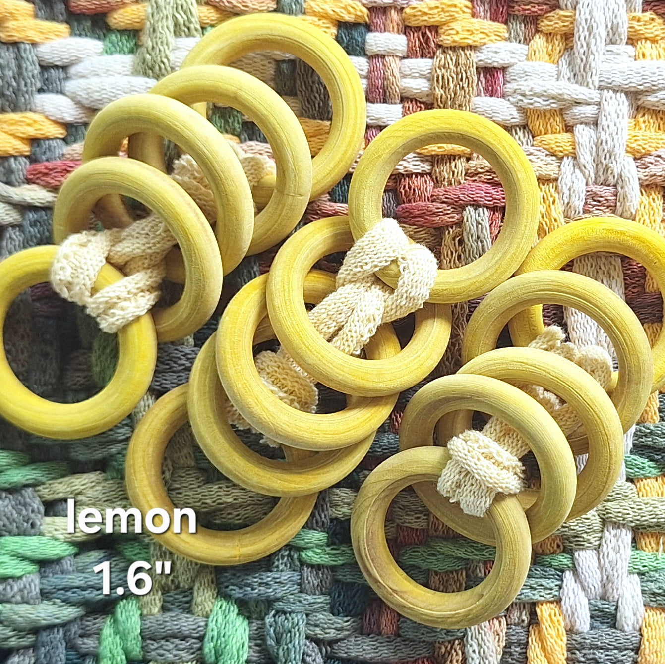 sets of yellow wooden rings on a woven potholder