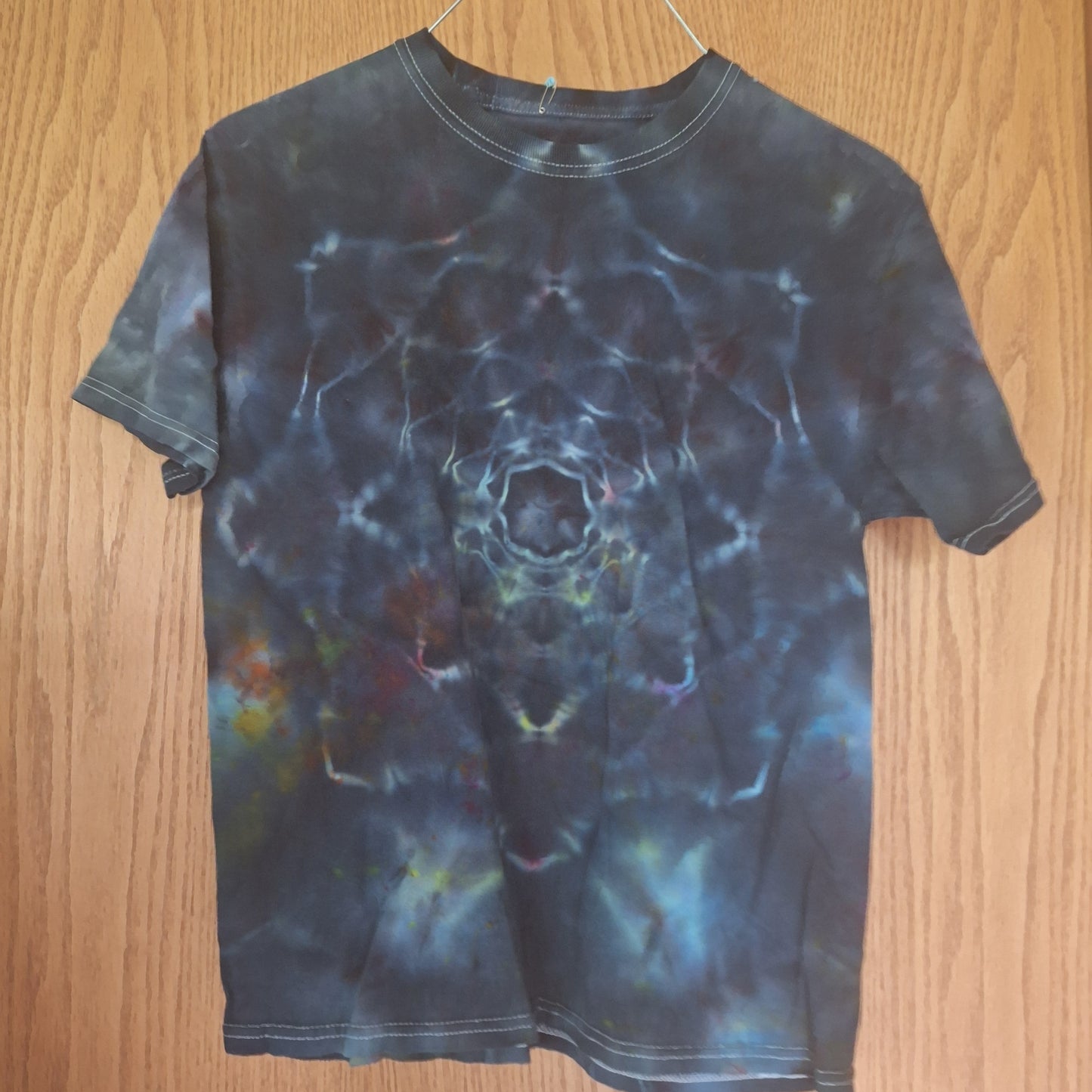 Tie-dye shirt on a wooden surface