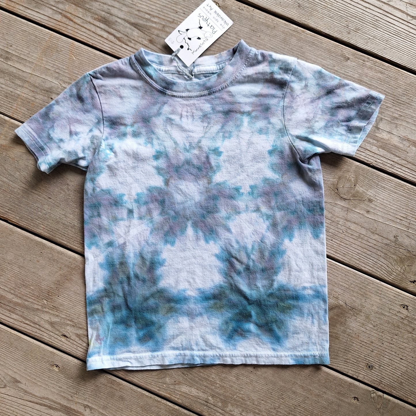 Tie-dye t-shirt on a wooden surface