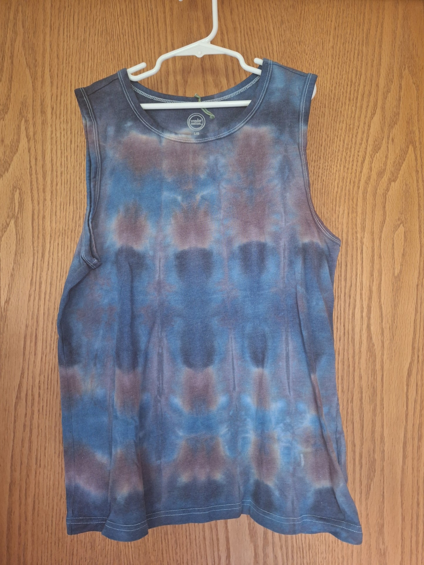 Blue tie-dye tank top on a wooden surface