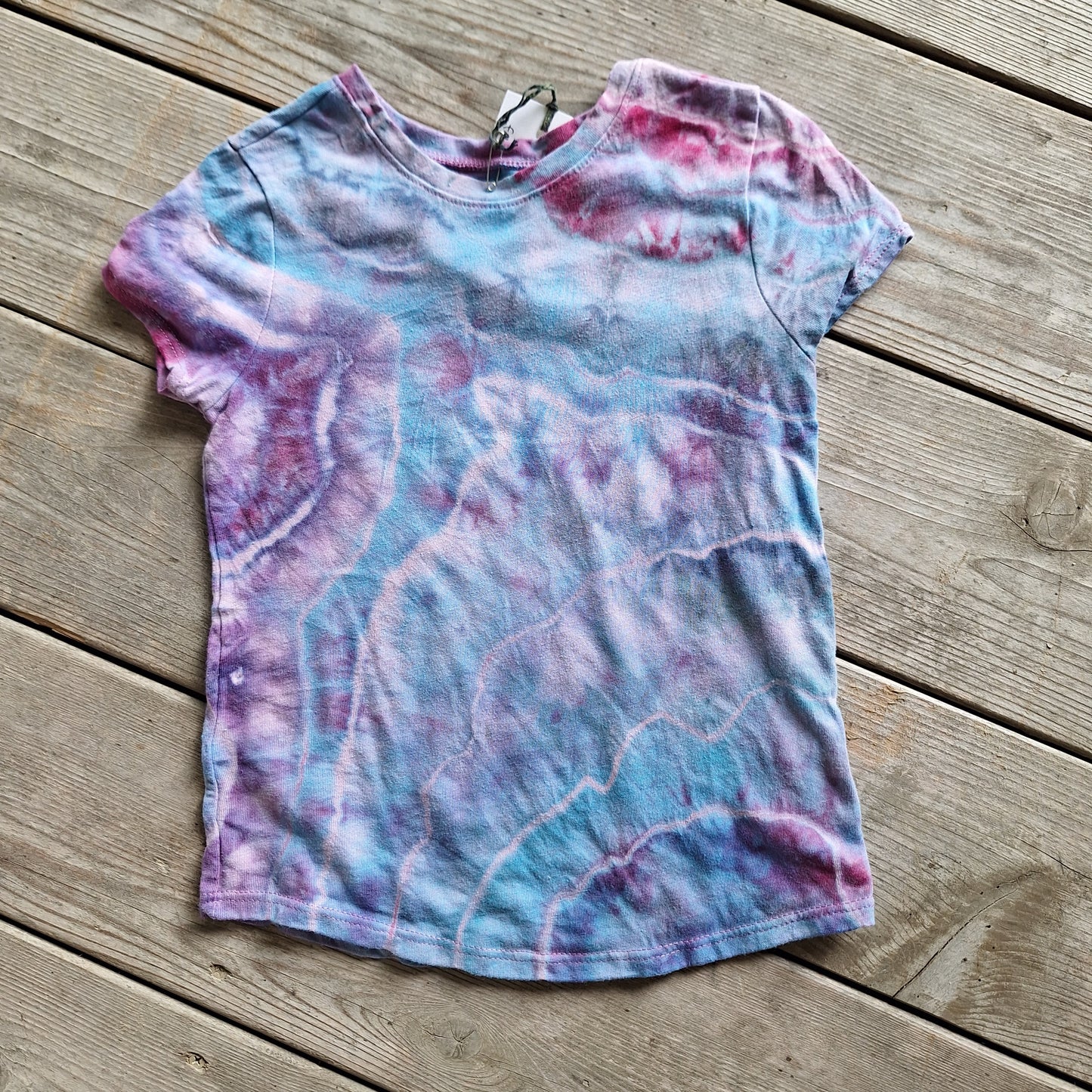 Tie-dye t-shirt on a wooden surface