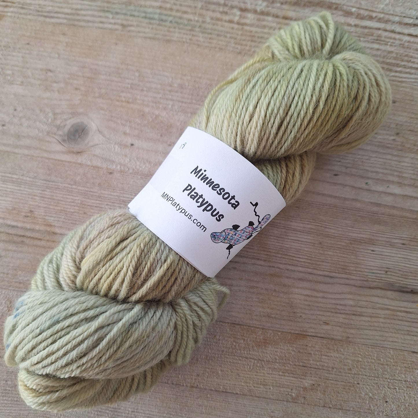 Skein of yarn with a label on a wooden surface