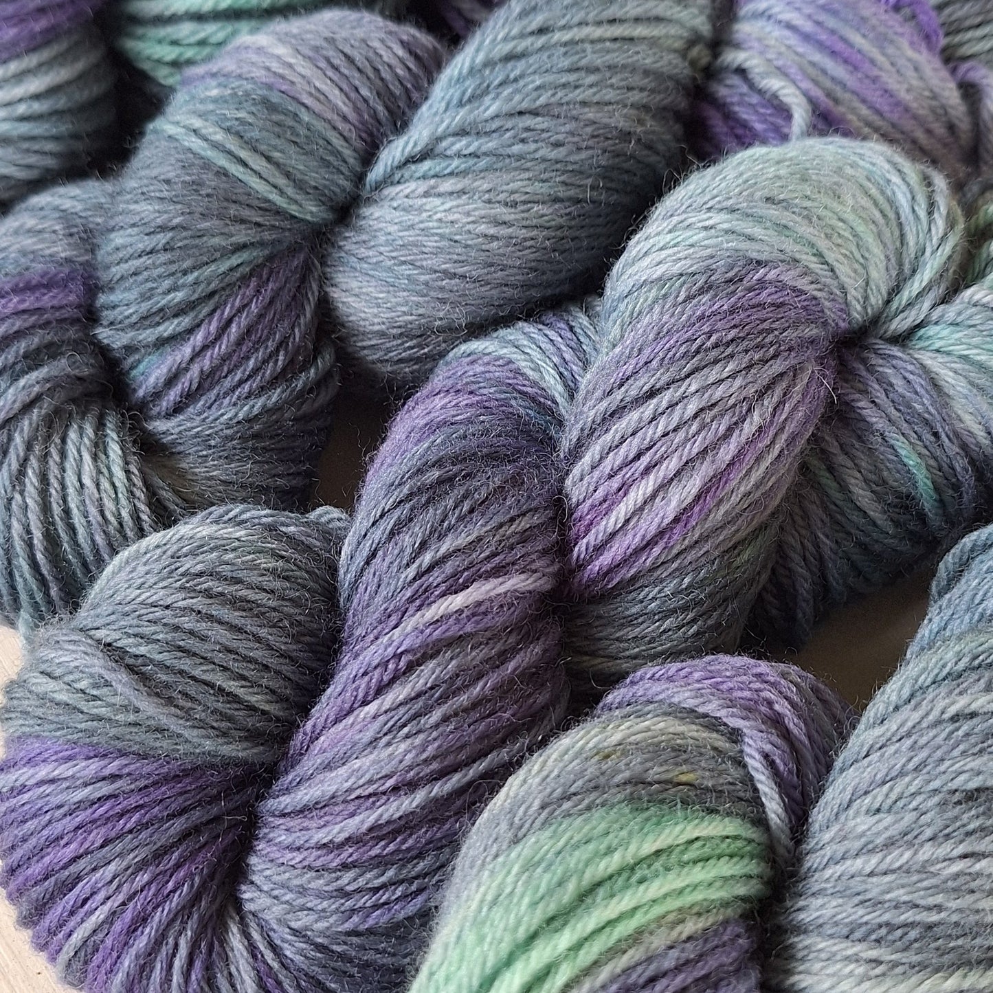 Multicolored skeins of yarn on a beige background