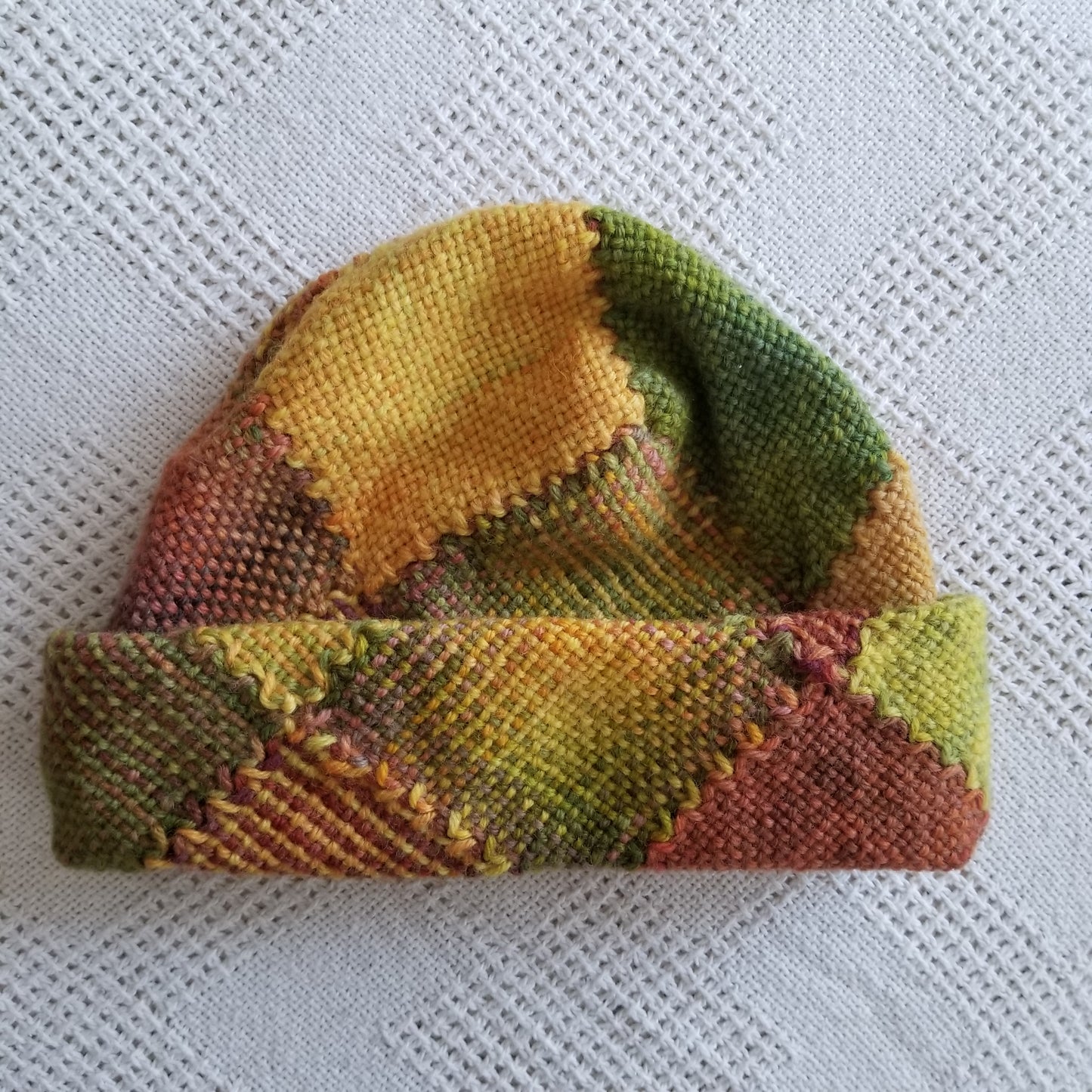 Tall Zoom Loom hat in fall colors, folded up twice