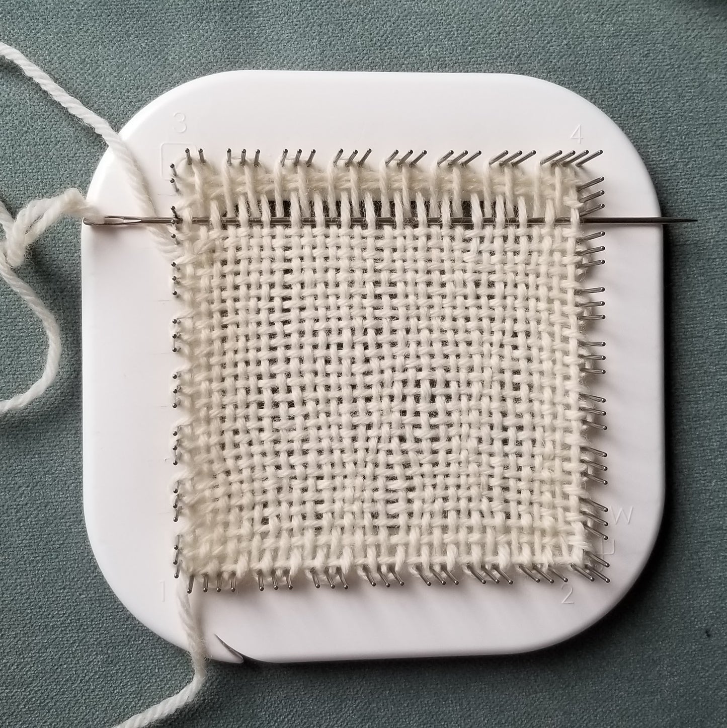 Weaving on the Zoom Loom with white yarn