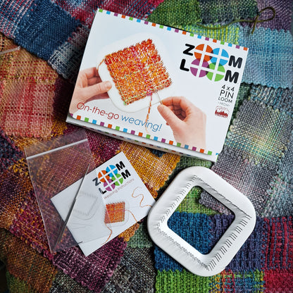 Zoom loom box and contents laying on a bed of woven squares