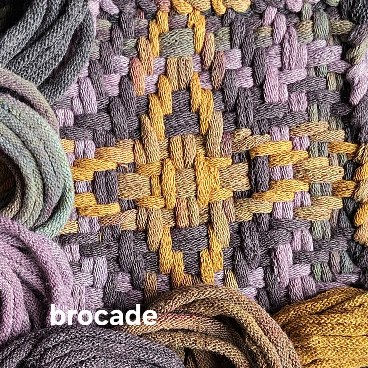 Close-up of woven textile with and bundles of potholder loops