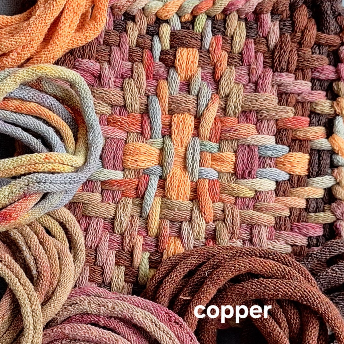 closeup of handwoven potholder in the chunky star pattern and copper colorway