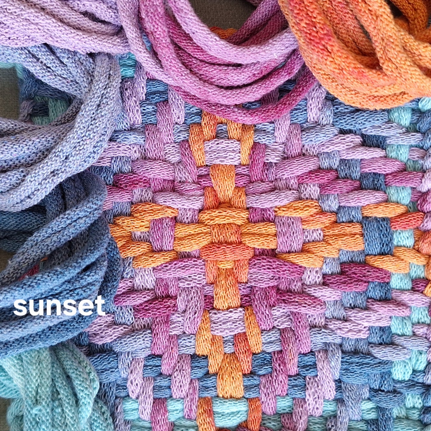 closeup of a woven potholder in the chunky star pattern and sunset colorway