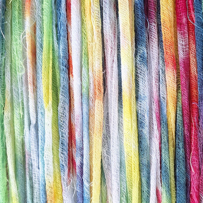 Close-up of colorful cotton gauze ribbon strands in a rainbow pattern