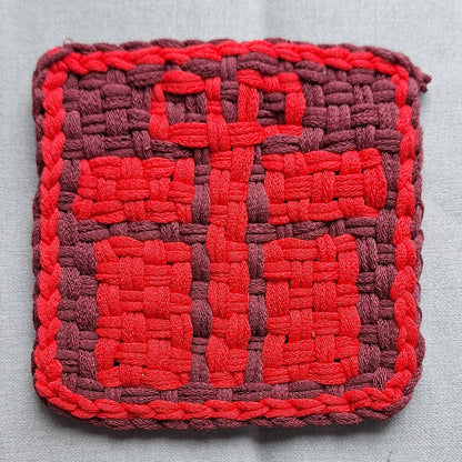 handwoven potholder depicting  gift box with a bow design