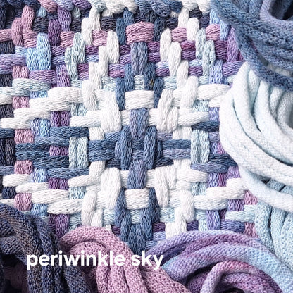 Close-up of woven trivet with periwinkle and sky blue colors.