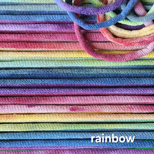 Close-up of colorful potholder loops with a 'rainbow' label.