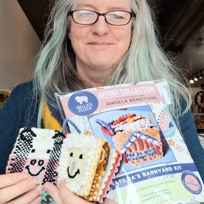 Angela holding a Matilda's barnyard booklet and completed project