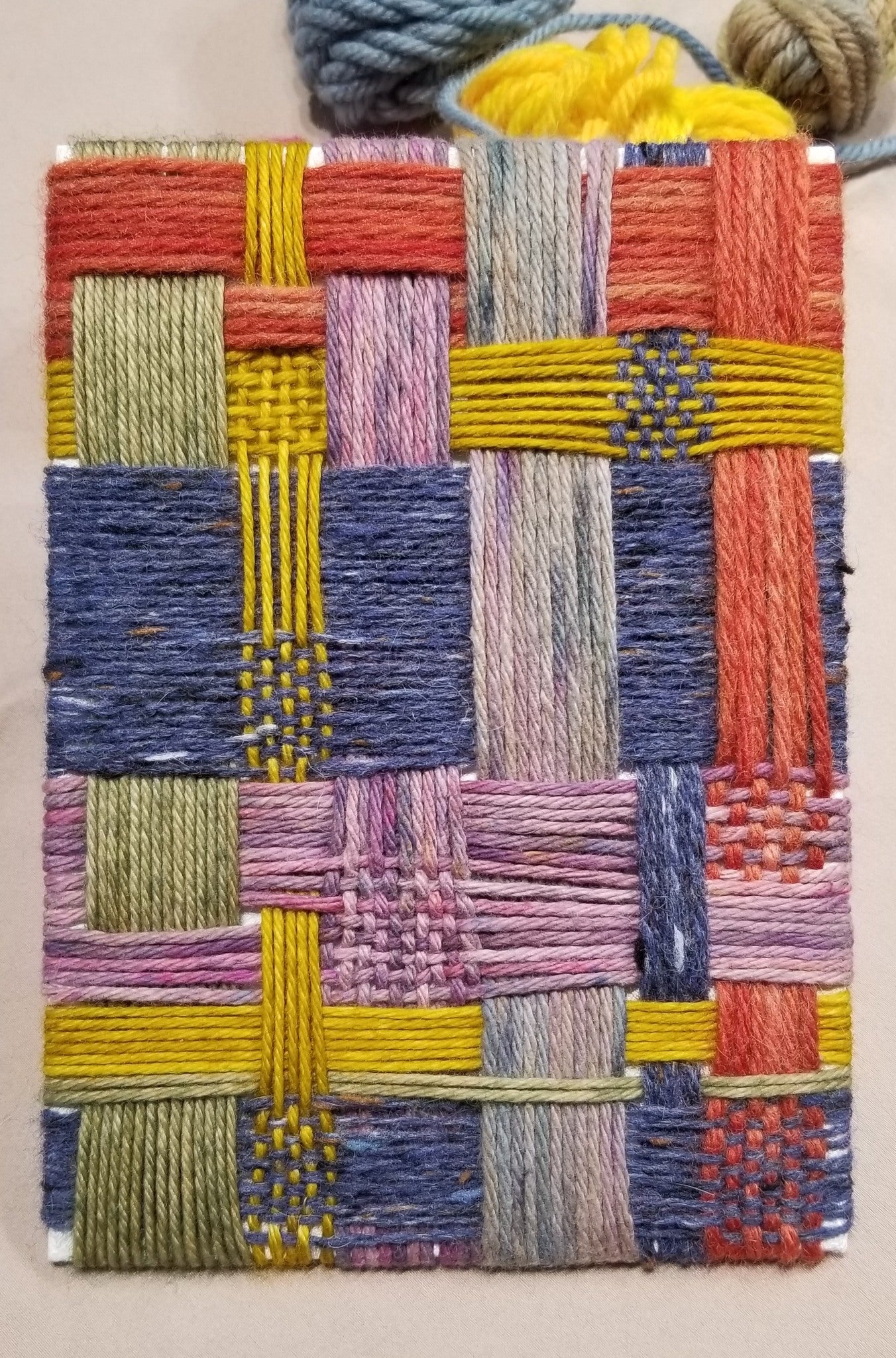 Woven sample with multicolored pattern on a plain background