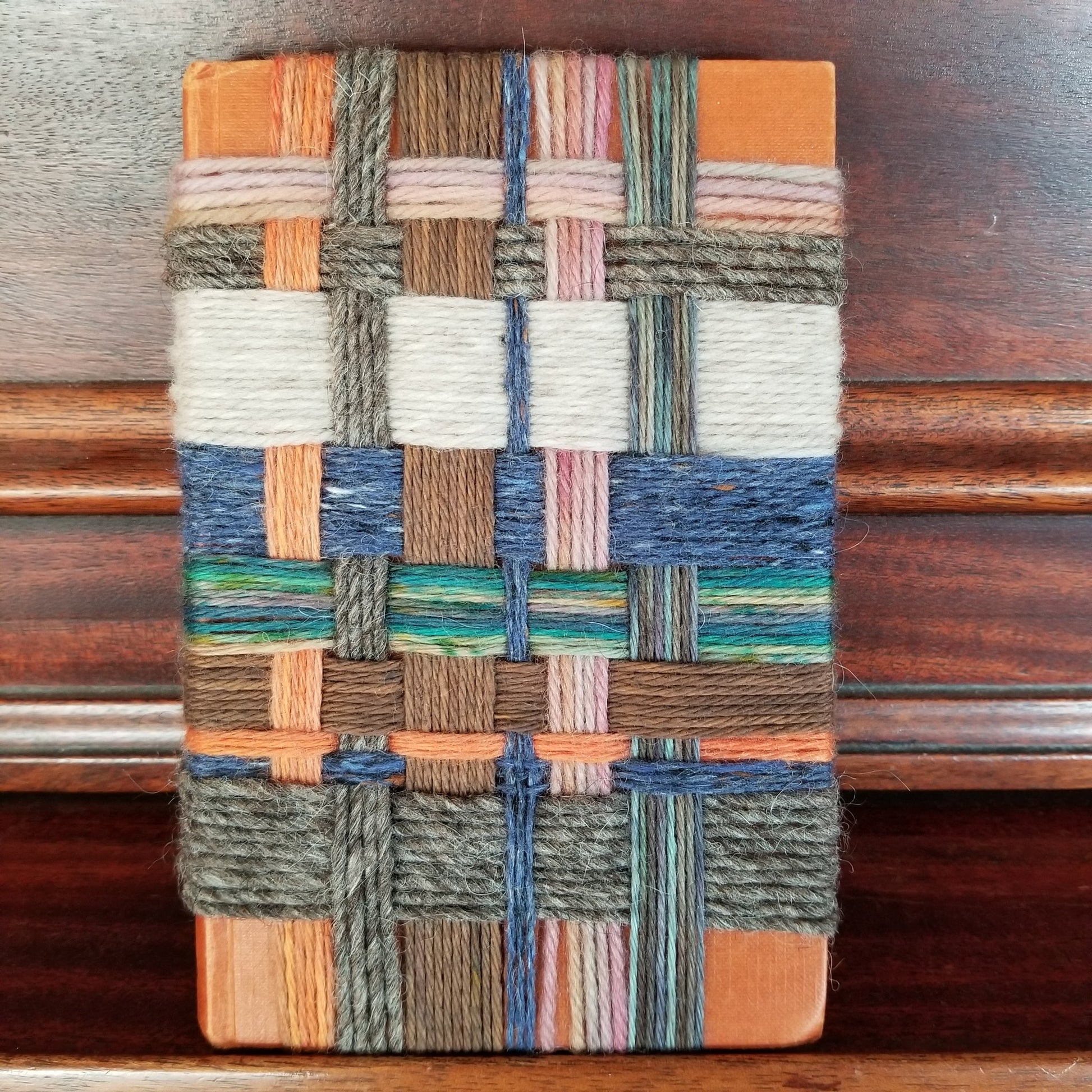 Woven sample with multicolor pattern on a wooden surface