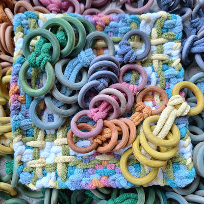Colorful woven potholder with dyed wooden rings 