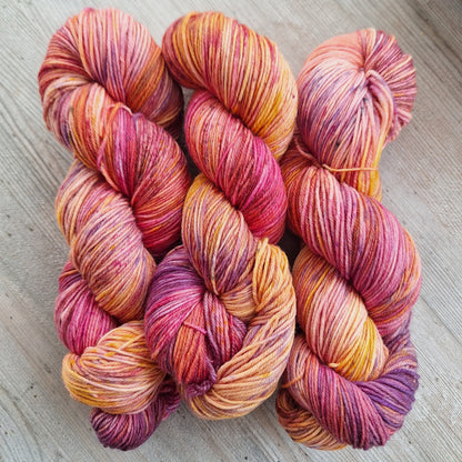 Multicolored skeins of yarn on a wooden surface