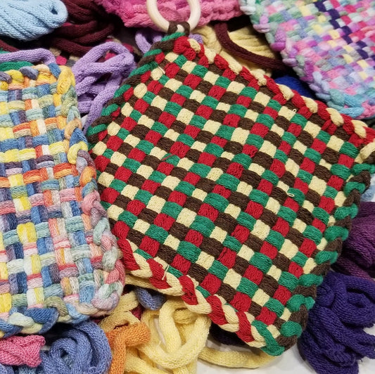 Colorful woven potholders on a bed of loops