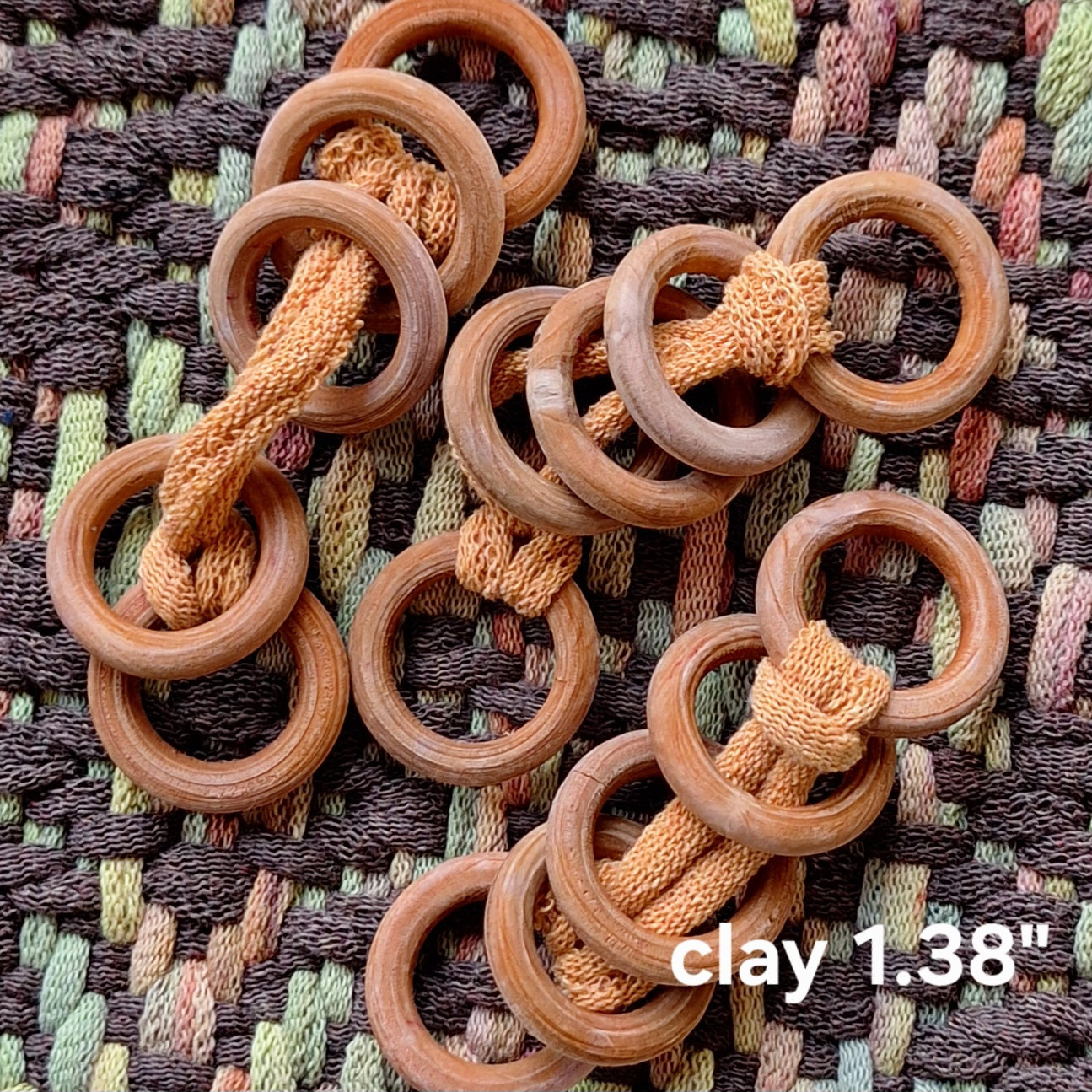 wooden rings on a textured fabric background