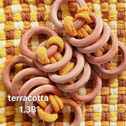 sets of orange wooden rings on a woven potholder
