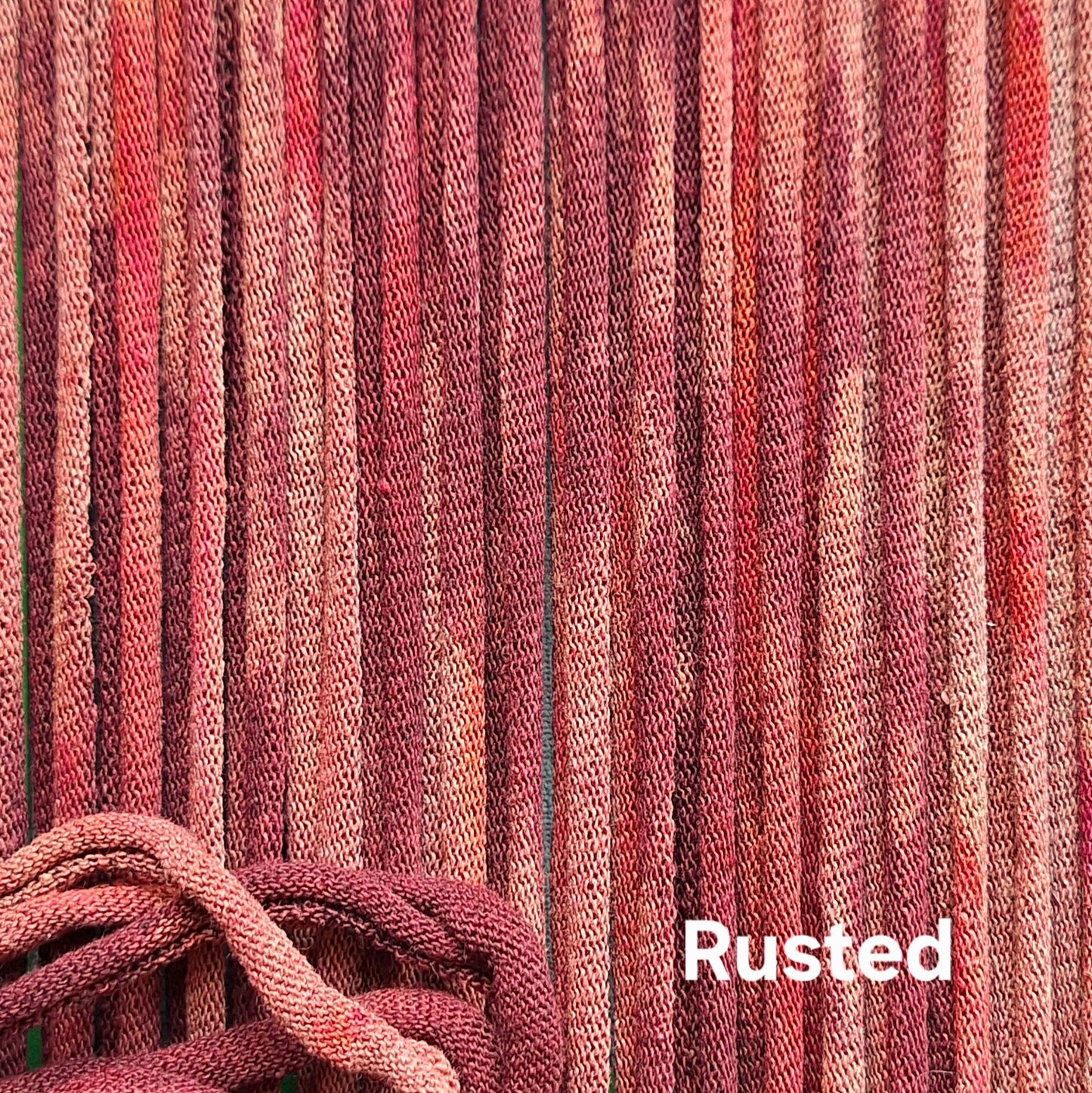 Close-up of rust-colored cotton loops with a textured pattern