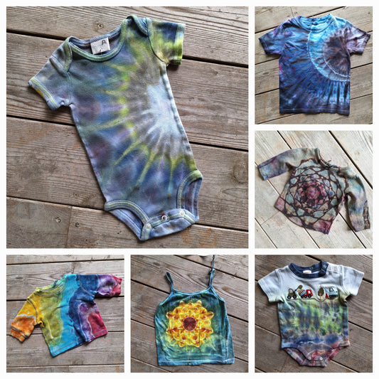 Collage of tie-dye baby clothing on a wooden surface