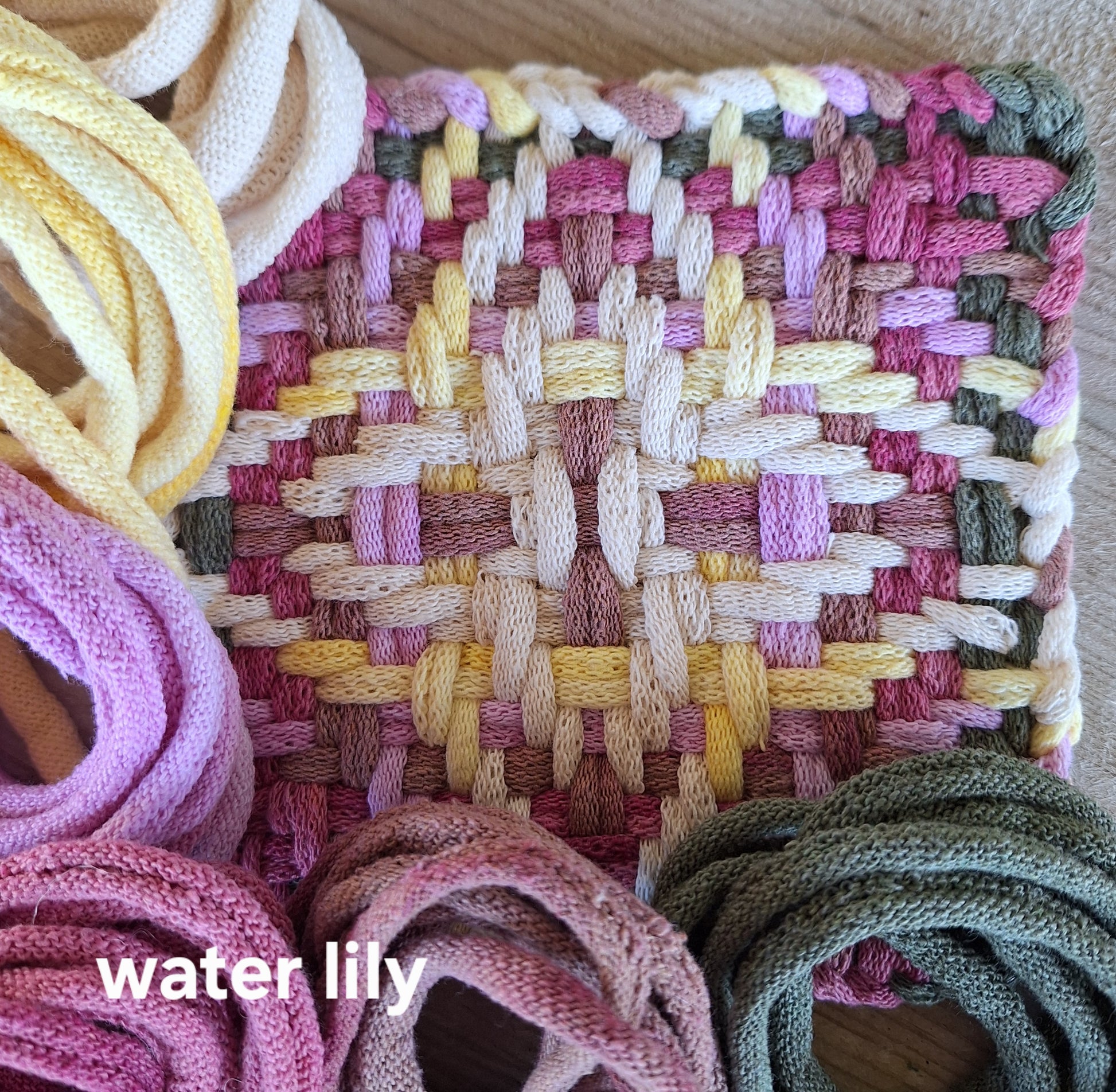 potholder woven in the Chunky Star pattern with the pink and yellow Water Lily colorway