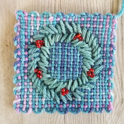 embroidered wreath on a woven square