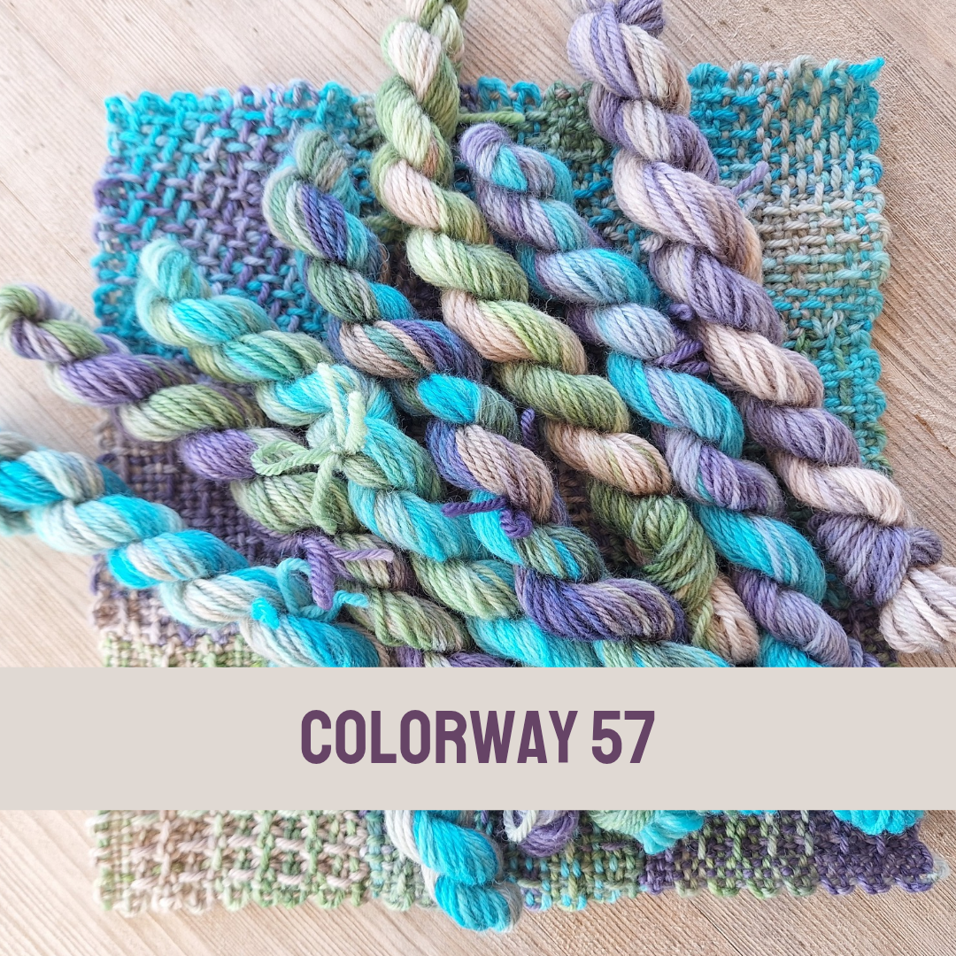 Colorful yarn skeins with woven samples on a wooden surface, labeled 'Colorway 57'.