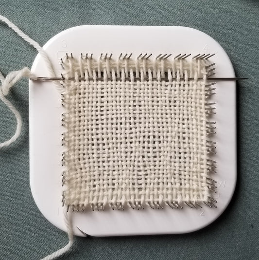 Weaving on the Zoom Loom with white yarn
